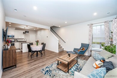 Living room with light hardwood / wood-style floor