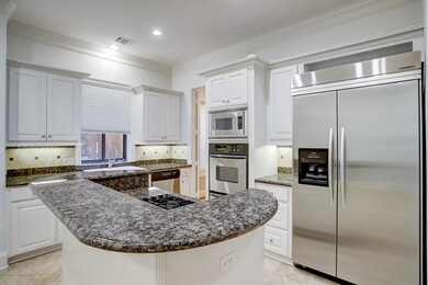 KITCHEN - ( 21 x 13) KitchenAid appliances, including double ovens, and a Jenn-Air gas cooktop complete this chef's kitchen.