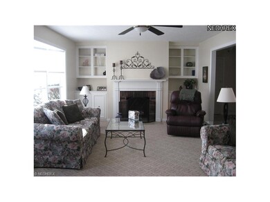 Charming living room with fireplace and built-ins.
