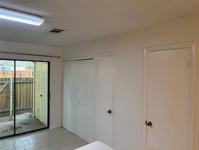 Unfurnished bedroom featuring access to exterior,