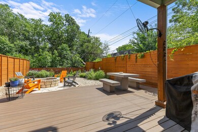 Wooden terrace with an outdoor fire pit, a fenced