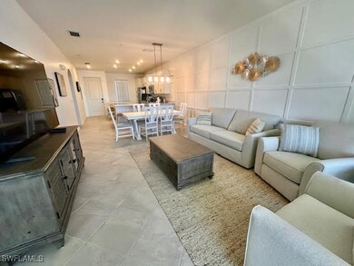 Living area with visible vents and a decorative wall