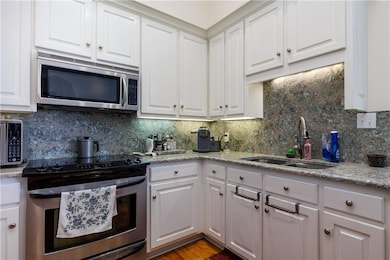 Kitchen with stainless steel appliances, backsplas