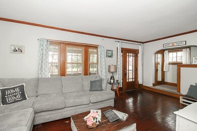 Roomy living room with original hardwood floors.