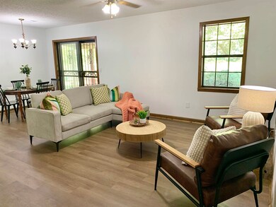 Living room with a textured ceiling, ceiling fan w