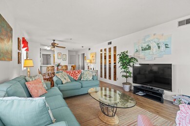 Living area featuring a ceiling fan, baseboards, v