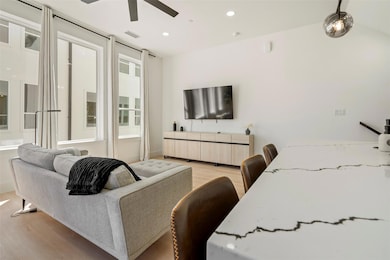 Living area with recessed lighting, light wood-sty