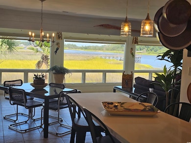 Dining area with an inviting chandelier, a water v