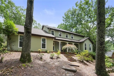 View of front of home featuring stairs and covered porch