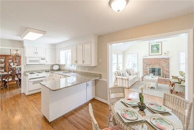 Kitchen has painted cabinets, granite countertops,
