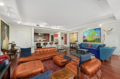 Living room with rail lighting, wood finished flo