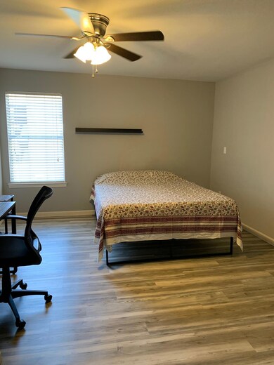 Bedroom featuring baseboards, ceiling fan, and wo
