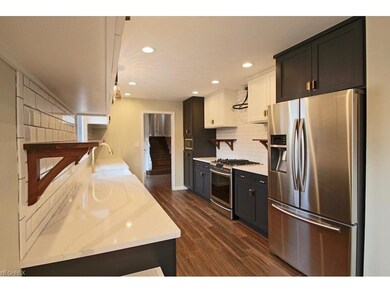 Spectacular custom kitchen has gorgeous quartz cou