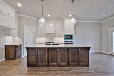 Kitchen with stainless steel oven, white cabinets,