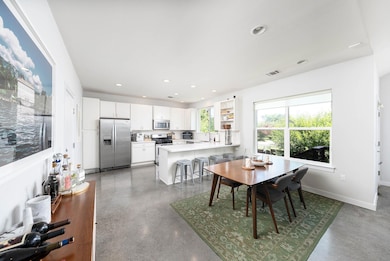 Dining space with recessed lighting and baseboards
