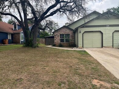 View of front of house featuring driveway, a gara