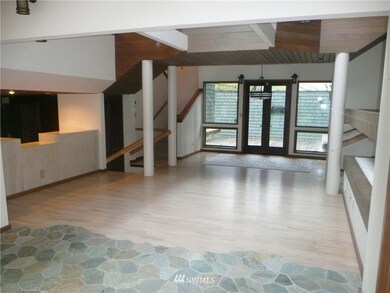 From the sun room you view the living area, formal dining area with deck and access to the lower and upper levels.