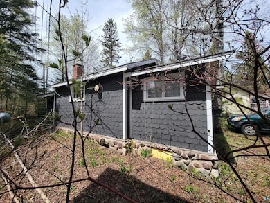 View of side of home with a chimney