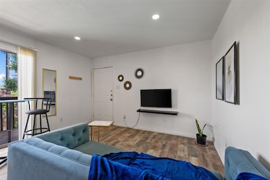 Living area with wood finished floors, recessed l