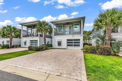 View of front of property featuring board and batten siding, a ceiling fan, decorative driveway, and a front yard