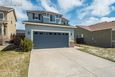 Traditional home featuring fence, driveway, a gara
