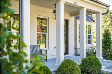 Property entrance with covered porch