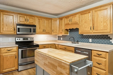 Your kitchen also has SS appliances including a built in microwave, farmhouse sink, tile backsplash, & and island providing extra space! 401 McClure St. Red Boiling Springs, TN 37150