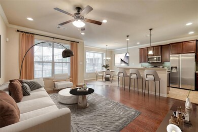 Living room with crown molding, ceiling fan, rece