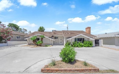 Ranch-style house with concrete driveway and a chi