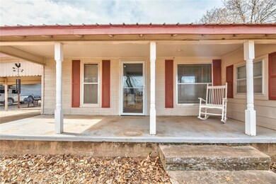 View of exterior entry featuring covered porch