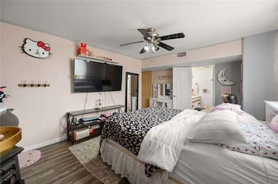 Bedroom featuring dark wood-style flooring and a ceiling fan