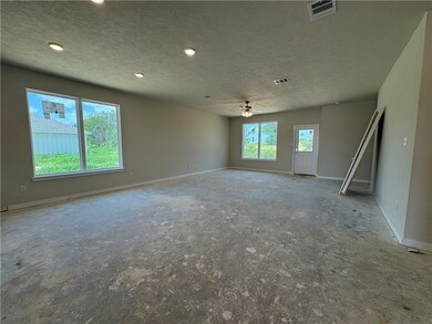 Unfurnished room featuring a textured ceiling, cei