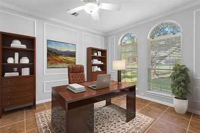 This designated office space features a ceiling fan, crown molding, built-ins, and can be used however you'd like. *virtually staged