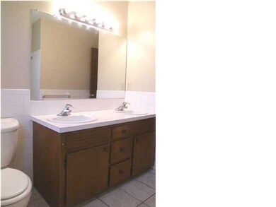 The vanity features double sinks and updated light