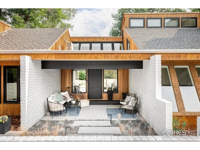 A covered front patio with skylights, lush landscaping, and striking curb appeal set a welcoming tone.