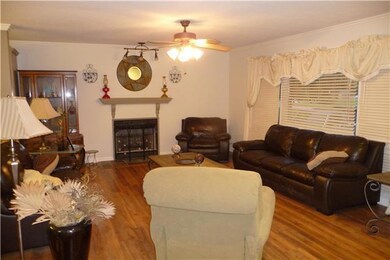 The living room with beautiful laminate floors! Very open floor plan with a gas fireplace to relax by on those chilly evenings.