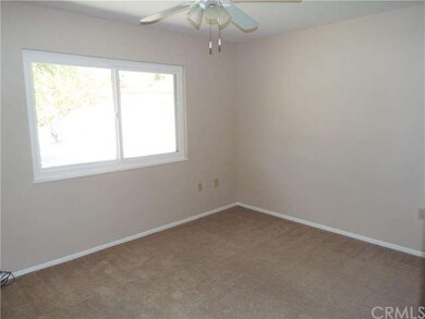 Back bedroom overlooking the yard with a ceiling f