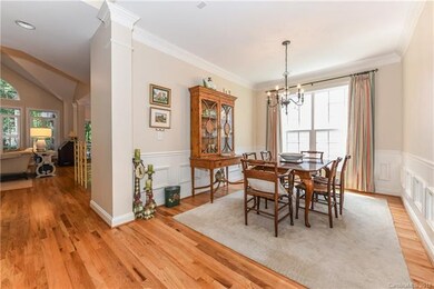 Open Dining Room with crown molding and wainscoati