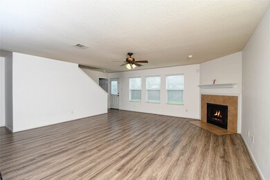 No carpet downstairs! Looking from the front door into the living area. Three windows look out into the back yard. The open door leads into the downstairs bedroom/office/flex room.