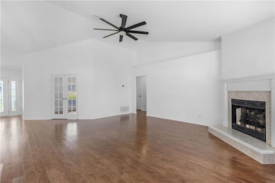 Unfurnished living room with french doors, dark wo
