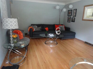 Living Room boasts Hardwood Floors and Coved Plast