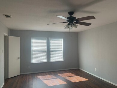 Unfurnished room featuring dark wood finished floors and ceiling fan