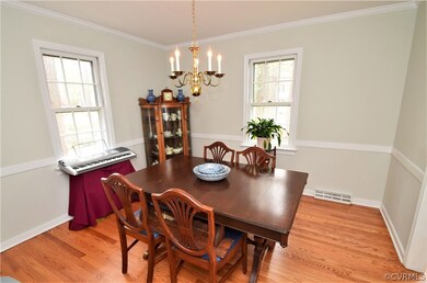 The Formal Dining Room Features Crown Moulding and