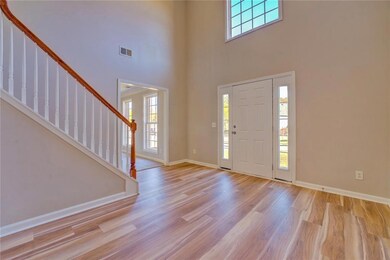 Entryway with light wood-type flooring and a tower
