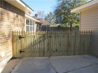 Exterior Back. Cute fence divides driveway from ba