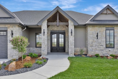 Stone and stucco siding Class 4 roof and fully landscaped!