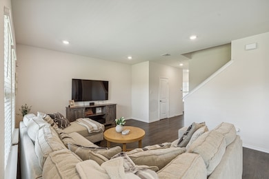 Living room featuring dark wood-style floors and recessed lighting