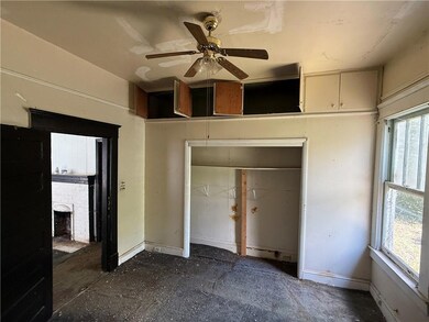 Unfurnished bedroom featuring a closet, a fireplace, and ceiling fan