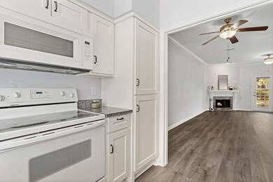 Unfurnished living room with ceiling fan, dark har