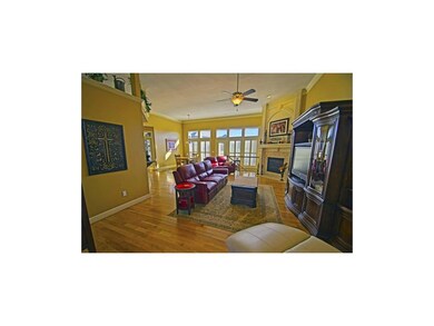 Great room with hardwood floors, 12' ceilings and 